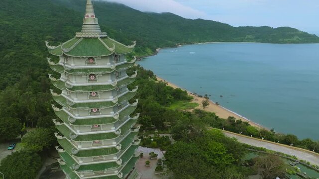 Aerial View of Thap Xa Loi Pagoda Tower in Da Nang, Vietnam
Vietnamese Buddhist architecture, green tiled roofs, and ornate carvings set against the lush mountains of the Son Tra Peninsula in Da Nang