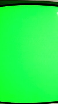 Retro Technology Display with 1990 s tv slow push in green screen distortion, overlay, glitch, static noise, scan lines on black background, 4k animated video loop