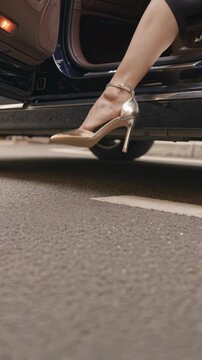 Elegant woman stepping out of a luxury car &mdash; polished arrival, vertical footage