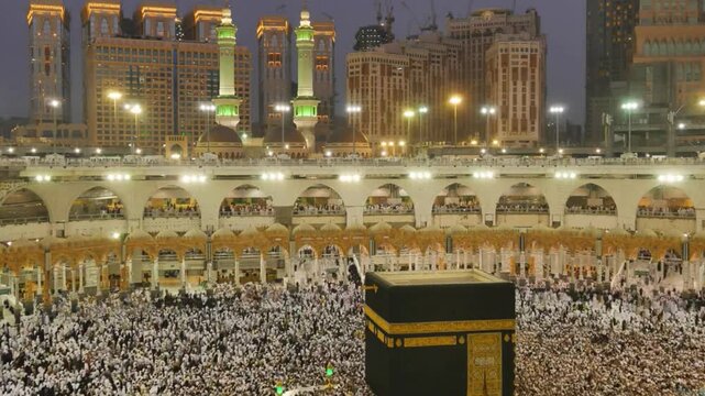 Mesmerizing and serene view of Kaaba in Masjid al-Haram at night with pilgrims during Hajj or Umrah. Holly place for Muslims . Eid Mubarak and Ramadhan Kareem 