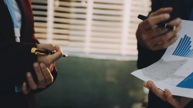 Close up of businessman or accountant hand holding pen working on calculator to calculate business data, accountancy document and laptop computer at office, business concept
