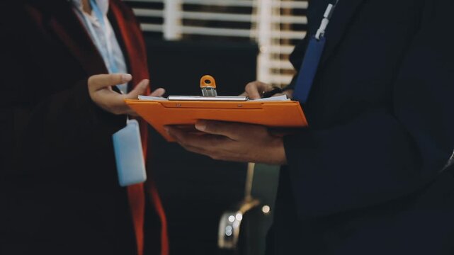 Close up of businessman or accountant hand holding pen working on calculator to calculate business data, accountancy document and laptop computer at office, business concept