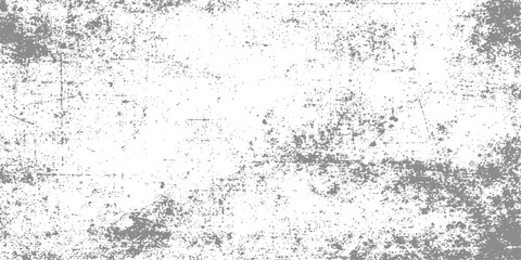 An old dirty grey concrete wall with a rough grunge texture and paint splatters creates a vintage textured stone pattern backdrop for artistic design