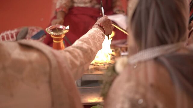 Hindu Wedding Ceremony: Couple Offering Oblations into the Sacred Yagna Fire