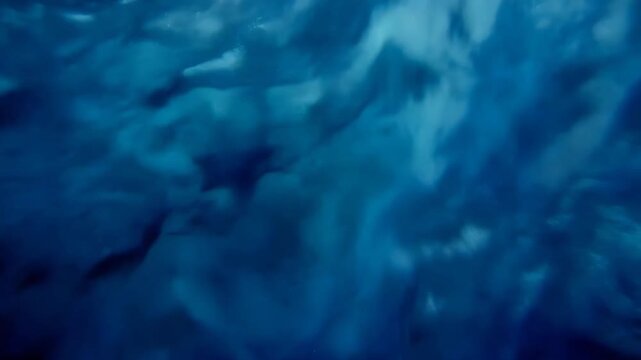 Abstract deep blue turbulence background with chaotic swirling currents and eddies