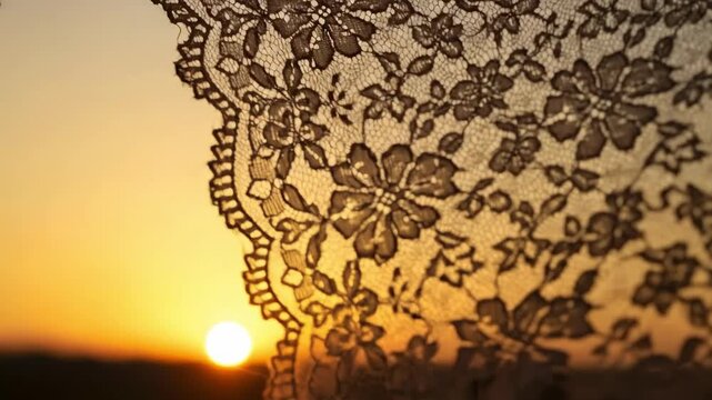 Vintage floral lace fabric silhouette against golden sunset sky, bohemian wedding veil texture