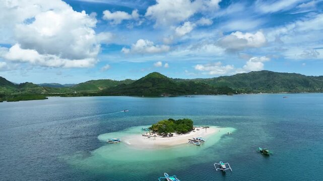 Elevated angle reveals atoll and steep forested hill, Gili Tangkong, Indonesia