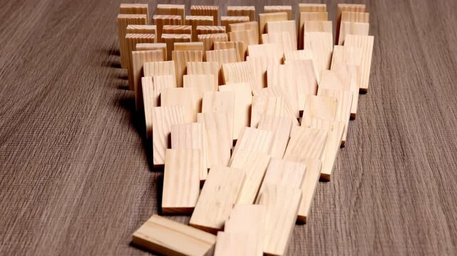 Butterfly effect. Wooden dominoes falling over in motion probability future chance metaphor chain reaction, a powerful metaphor for potential energy, concept opportunity, innovation, new beginning