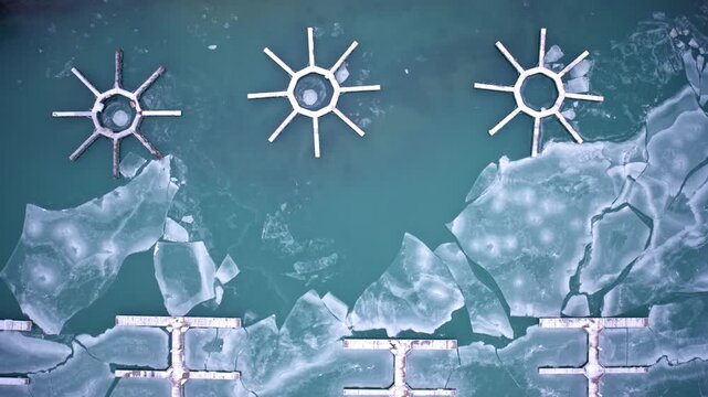 Aerial drone footage of winter ice covering harbor waters along Lake Michigan near Chicago Loop skyline.