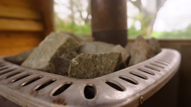 Close up of hot rocks in sauna ready to pour water and create steam. Luxury spa treatments, self-care routines, stress reduction. Part of routine for longevity.