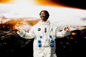 Fototapeta premium Cheerful orbital station astronaut delighted by beauty of planet in space. Jolly African american woman looking in awe at galaxy celestial bodies during planetary exploration research mission
