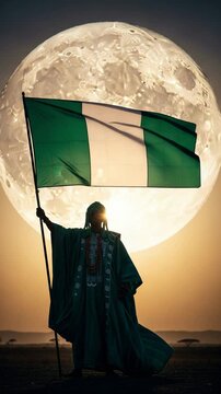 Patriotic Nigerian man in traditional attire holding flag with giant moon background for Independence Day