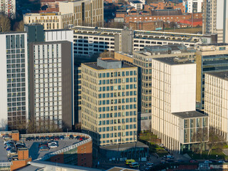 Fototapeta premium Aerial drone view of modern apartment towers and office buildings near Leeds city centre in West Yorkshire England showing contemporary urban development in the winter time