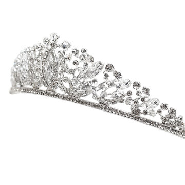 Elegant, ornate tiara with sparkling gemstones against a stark black background