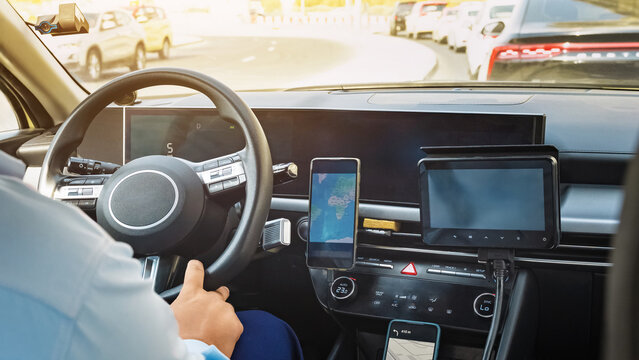 Taxi working at a busy intersection with a screen showing directions in the vehicle