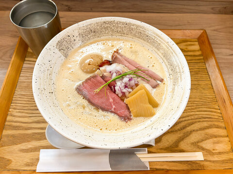 Japanese shrimp ramen with creamy espuma topping and roast beef slices