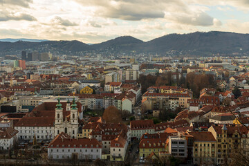 Fototapeta premium Cityscape with Red Tile Roofs, Church Towers and Hills