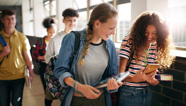 Hallway, friends and teenager with phone at school, academy gossip forum and education joke for laugh. Reading, smile or girls with mobile for funny academic meme, study app or check assessment grade