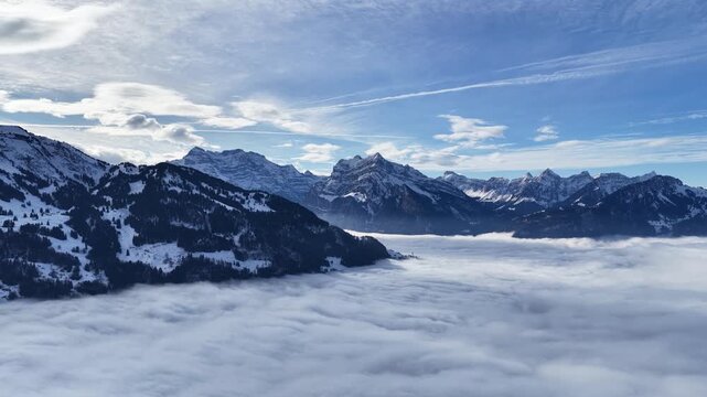 Snowy Alps rising above cloud inversion near Walensee Walenstadt Switzerland