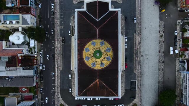 Teatro Amazonas and Largo de S&atilde;o Sebasti&atilde;o square in Manaus, Brazil during cloudy afternoon. Top-down aerial ascent over the theatre roof with cars passing by on street. 4K wide.