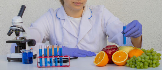 Female scientist checking fresh fruit quality in science laboratory