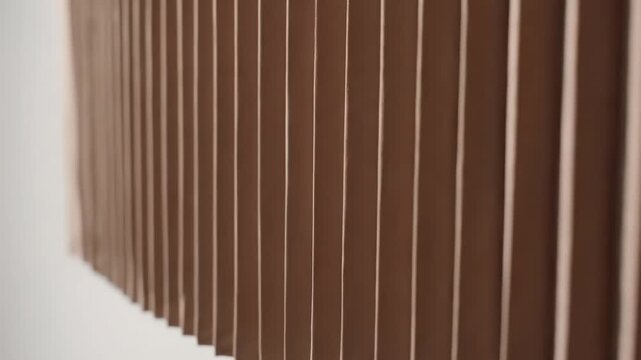 Closeup of brown vertical pleated texture or wall panel detail