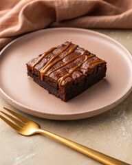 Indulging in rich chocolate brownies topped with caramel drizzle on an elegant pastel brown background a moody top-down view of decadent dessert perfection