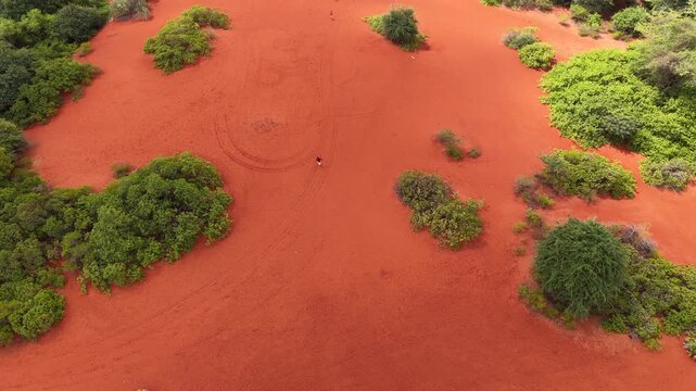 Aerial Slow Motion of Person Running Across Therikadu Red Sand Dunes