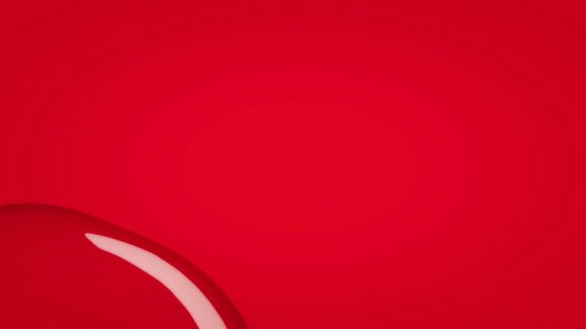 Partial view of a glossy red orb positioned in the lower corner of a crimson field creating dynamic negative space for high end branding and design