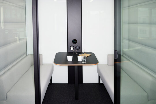 Modern interior of empty sofa with table in office booth