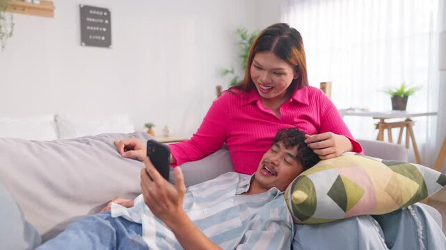 Asian transgender woman and her male partner enjoy daily life in house. 