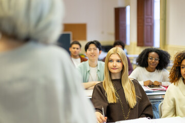 Diverse students attentively learning in university classroom