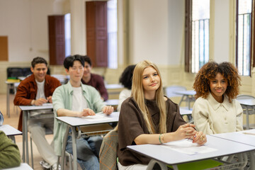 Obraz premium Diverse students learning together in a bright classroom