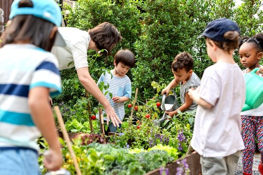 Children gardening with adult supervision.