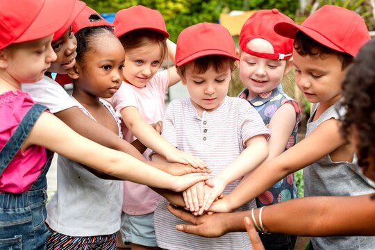 Diverse children teamwork unity outdoors.