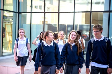 Students leaving modern school building.
