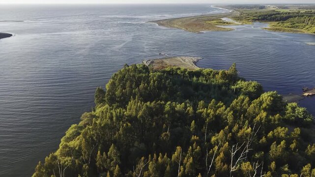 Aerial drone view of Isla Orrego where people lost their life on the 2010 tsunami in the Maule river when it meets the pacific, Constituci&oacute;n, Maule, Chile, 4K