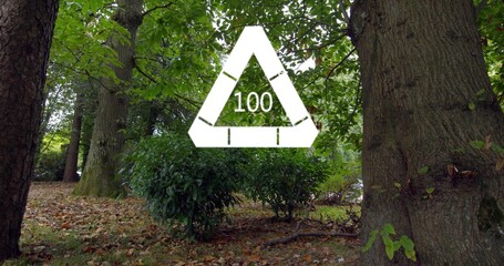 Naklejka premium Floating white triangular overlay showing 100 over park floor under leafy canopy, with tree trunks