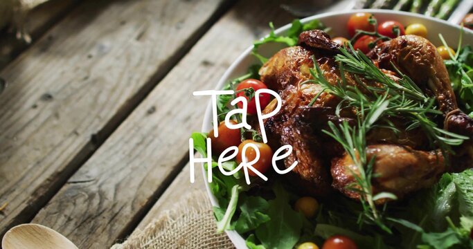 Showing white bowl holding roast chicken on dining table, with rosemary sprigs, red yellow tomatoes