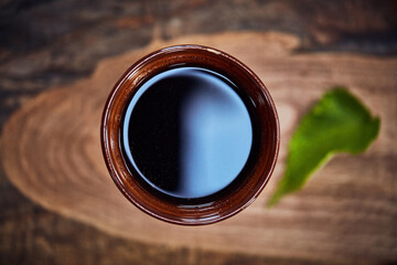 Herbal tea, glass or drink with mint leaf for nutrition, detox or natural medicine above. Top view, beverage and organic ingredients with cup for vitamin, homemade remedy or antioxidant on wood plank © peopleimages.com