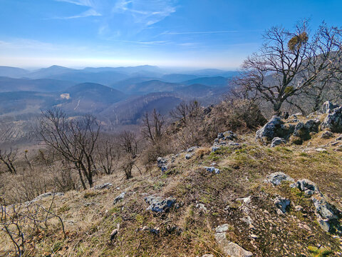 Panoramic mountain landscape from Harom-ko ridge in the Bukk Mountains, northern Hungary. Rolling forested hills and limestone cliffs dominate this scenic Central European landscape.