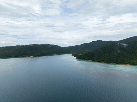 Aerial view of the serene Karimunjawa islands, where lush green hills meet the tranquil turquoise sea, Turtle Conservation, Karimunjawa, Central Java, Indonesia.