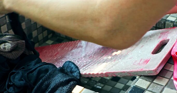 Traditional Housework of Hand Washing Clothes on a Washboard