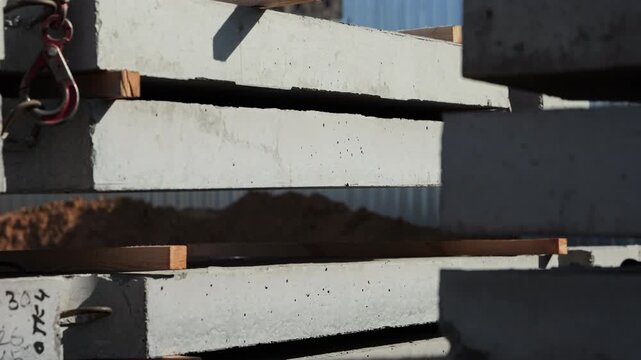 Crane stacking precast concrete slabs at construction site