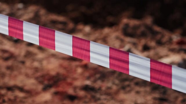 Red and white warning tape at construction site