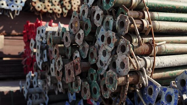 Stacked metal scaffolding props at construction site