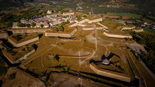 Aerial view of the fortified city's robust ramparts and geometric bastions standing as a testament to military architecture, Mont-Dauphin, Provence-Alpes-Cote d'Azur, France.