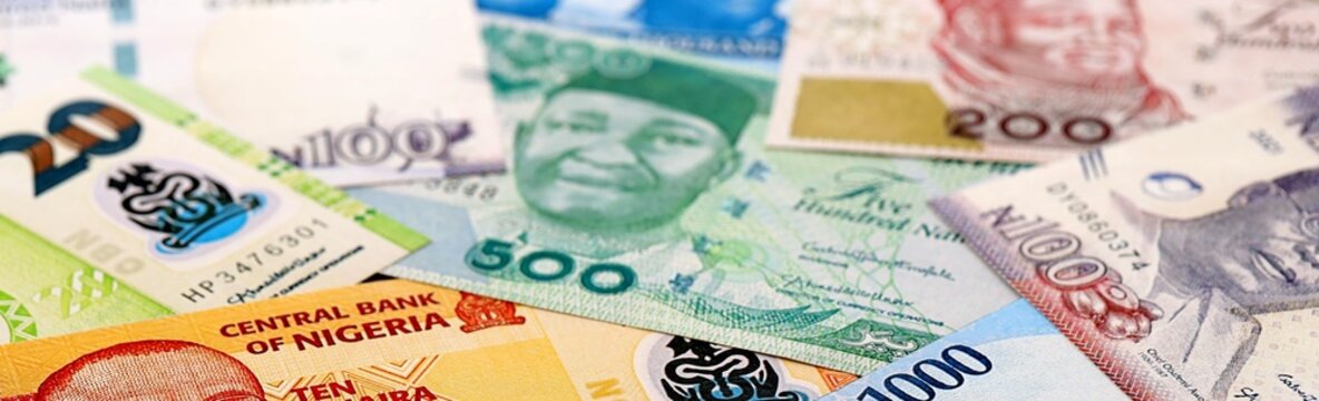 Nigeria naira money bills pile on table. Nigeria banknotes of NGN currency close up.