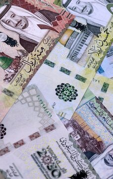 Saudi riyal money bills pile on table. Saudi Arabia banknotes of SAR currency close up.