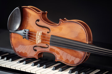 Violin on top of piano keys with black background